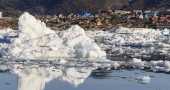Colorful buildings of Ilulissat sit on the edge of the town's ice choked harbor. Photo by Yvette Cardozo