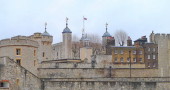 Skyline of the Tower of London showing light coloured walls and many towers